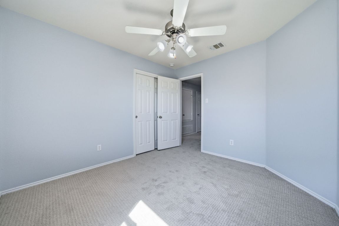 18153 Basket Flower Bend Elgin, TX 78621 - Photo 19 of 35 a view of an empty room with a chandelier fan
