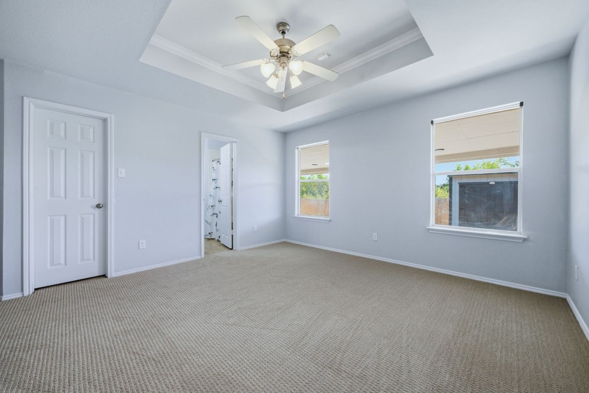 18153 Basket Flower Bend Elgin, TX 78621 - Photo 20 of 35 an empty room with windows and fan