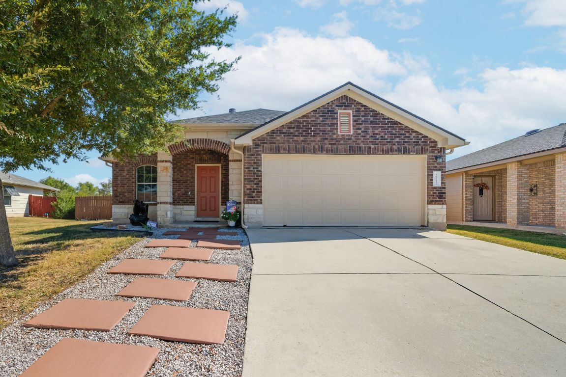 18153 Basket Flower Bend Elgin, TX 78621 - Photo 2 of 35 a view of a house with a yard and garage