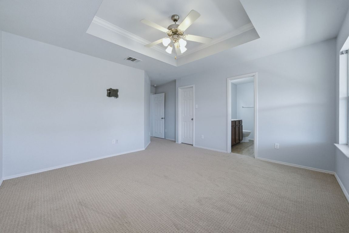 18153 Basket Flower Bend Elgin, TX 78621 - Photo 22 of 35 a view of an empty room with chandelier fan and window