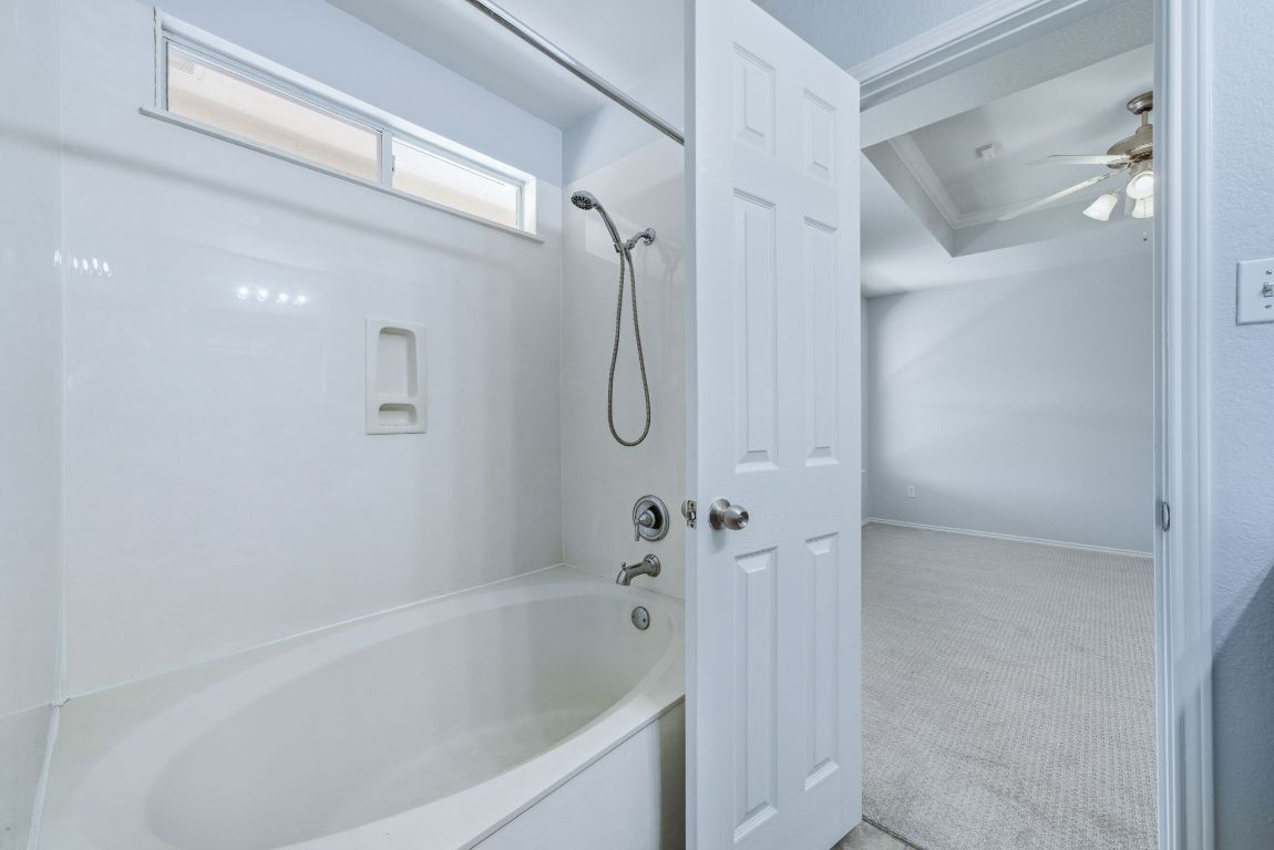18153 Basket Flower Bend Elgin, TX 78621 - Photo 27 of 35 a bathroom with a bathtub