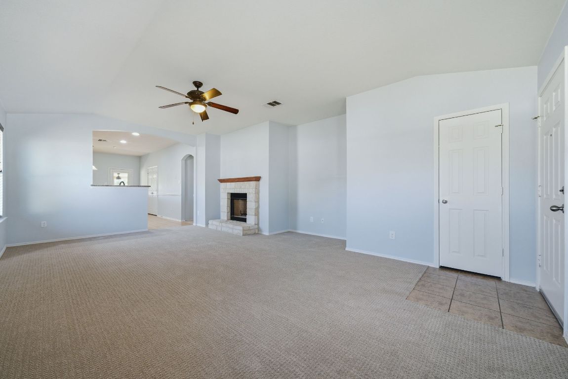 18153 Basket Flower Bend Elgin, TX 78621 - Photo 6 of 35 a view of a livingroom with a fireplace and a chandelier fan