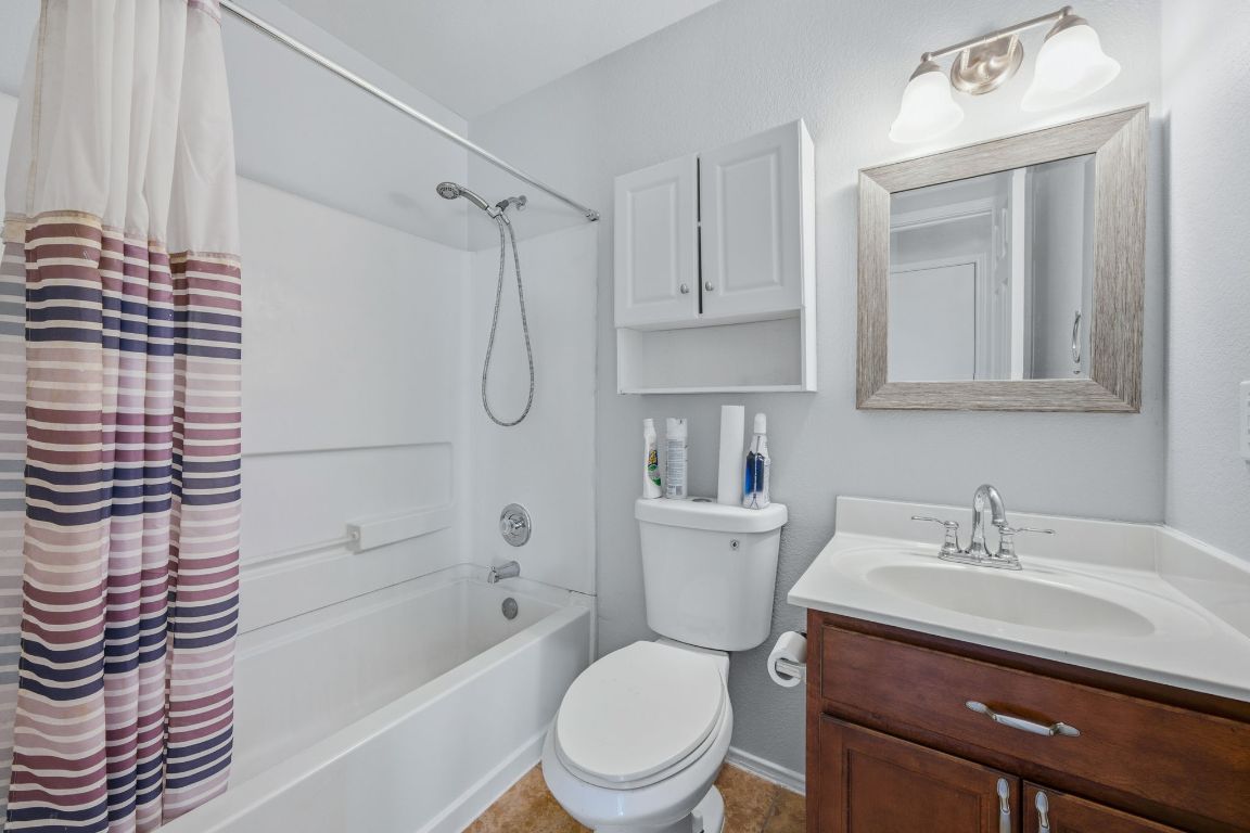 18153 Basket Flower Bend Elgin, TX 78621 - Photo 8 of 35 a bathroom with a sink a toilet and shower