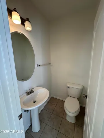 a view of a kitchen with kitchen island wooden floor and stainless steel appliances