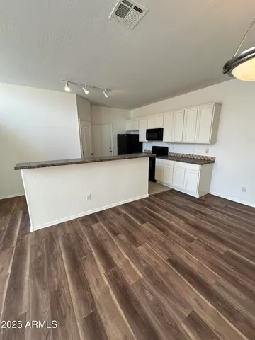 a view of kitchen with sink and wooden floor