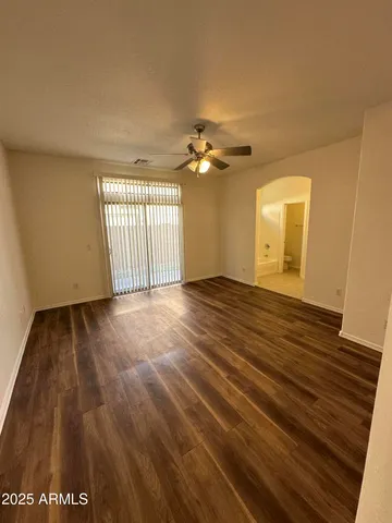 a view of a livingroom with a chandelier fan and a fireplace