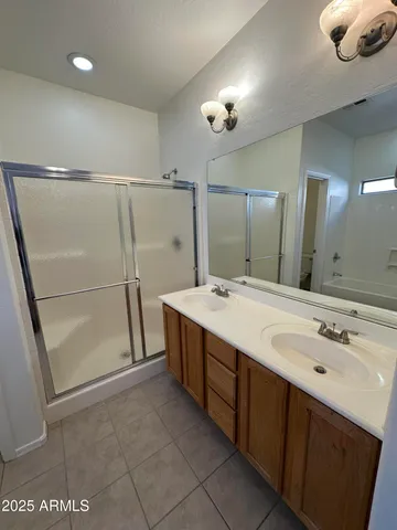 an empty room with windows and ceiling fan