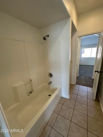 a white toilet sitting next to a shower