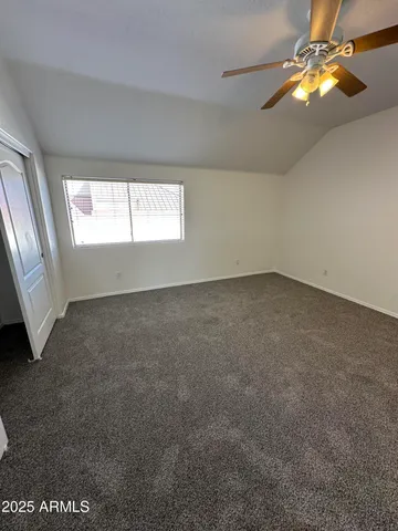 a view of a swimming pool with a yard and plants