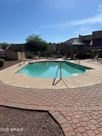 a view of a house with backyard porch and sitting area