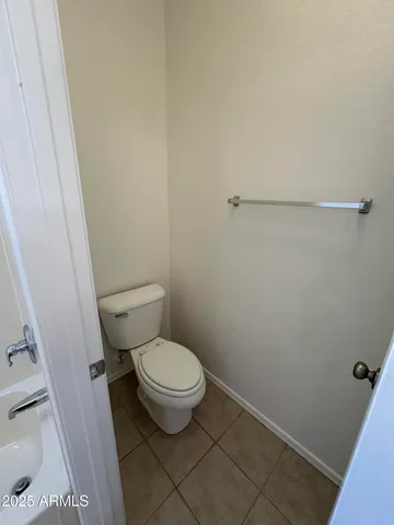 a white toilet sitting next to a shower