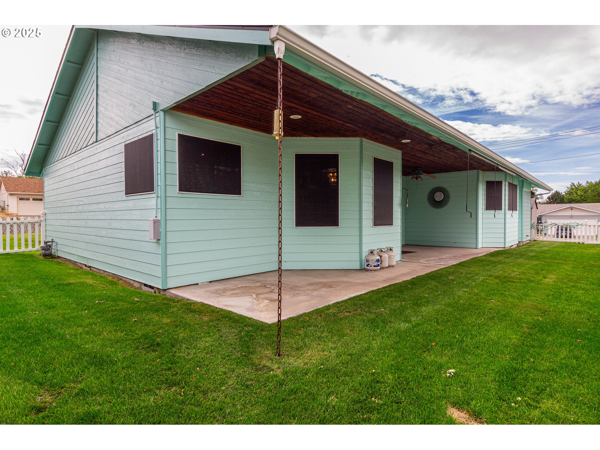 305 Northwest 9th Place Hermiston, OR 97838 - Photo 14 of 31 a view of a house with a backyard