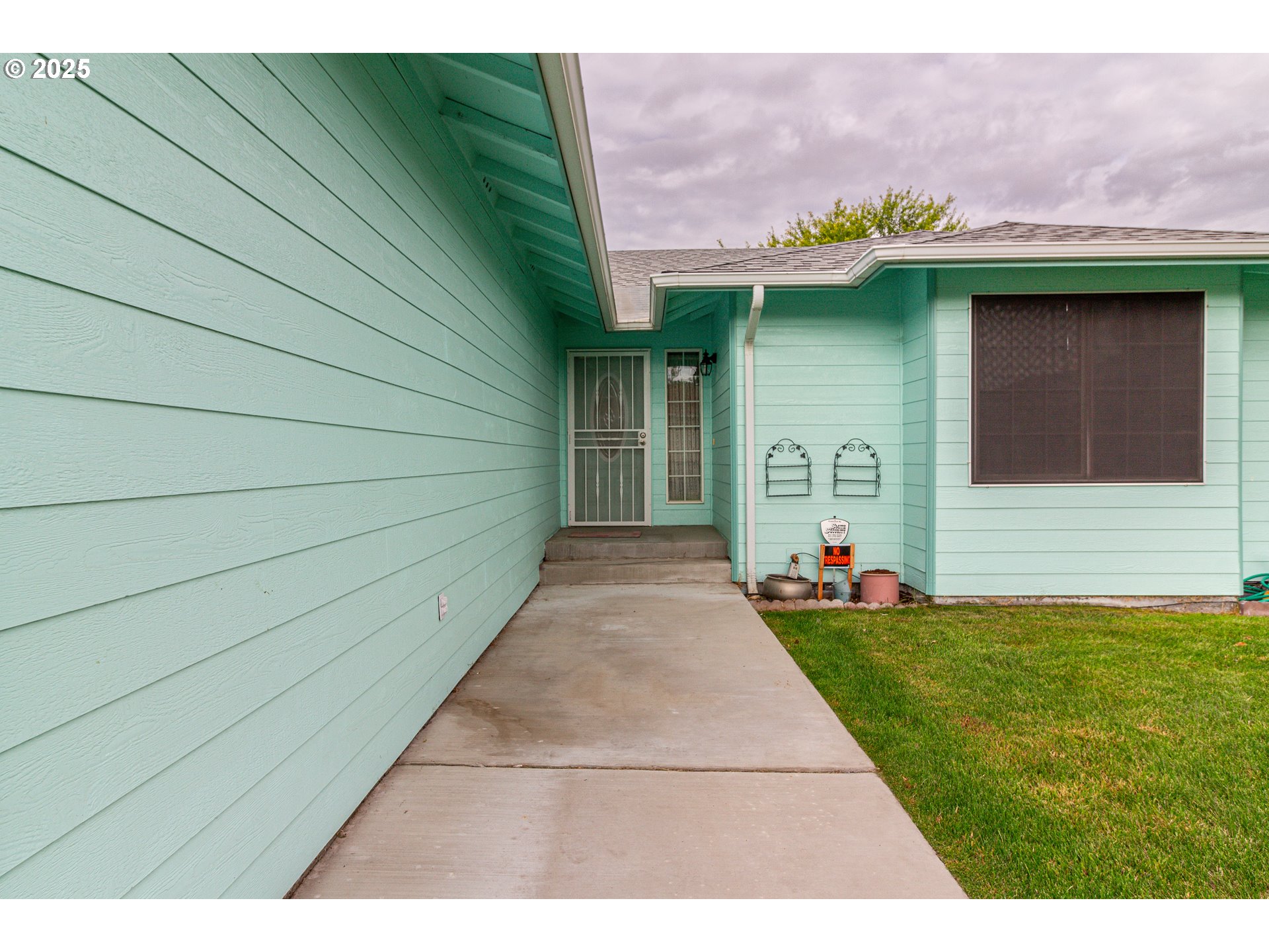 305 Northwest 9th Place Hermiston, OR 97838 - Photo 17 of 31 a view of a house with a yard and a garden