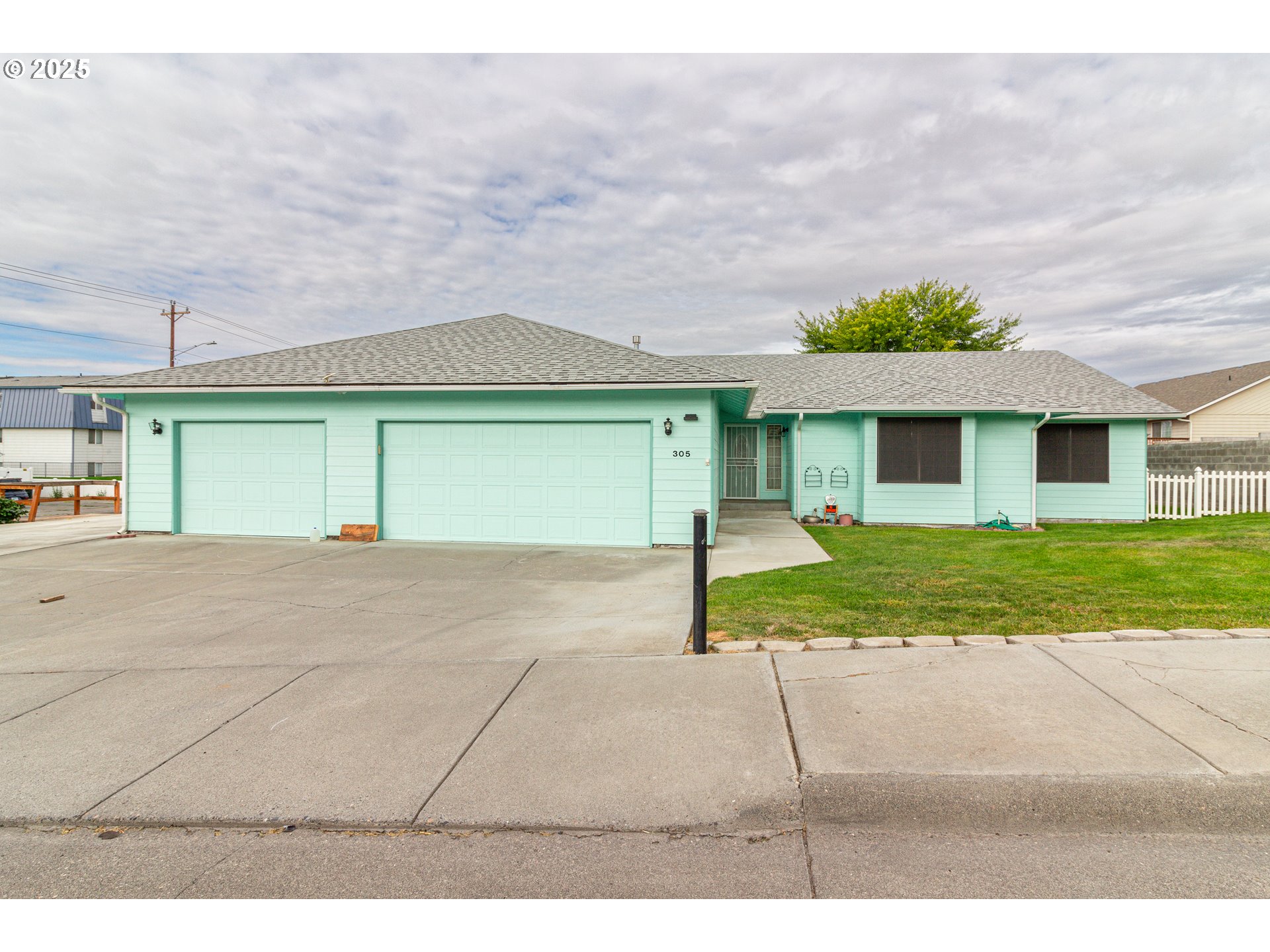 305 Northwest 9th Place Hermiston, OR 97838 - Photo 18 of 31 a view of a big house with a big yard and large tree