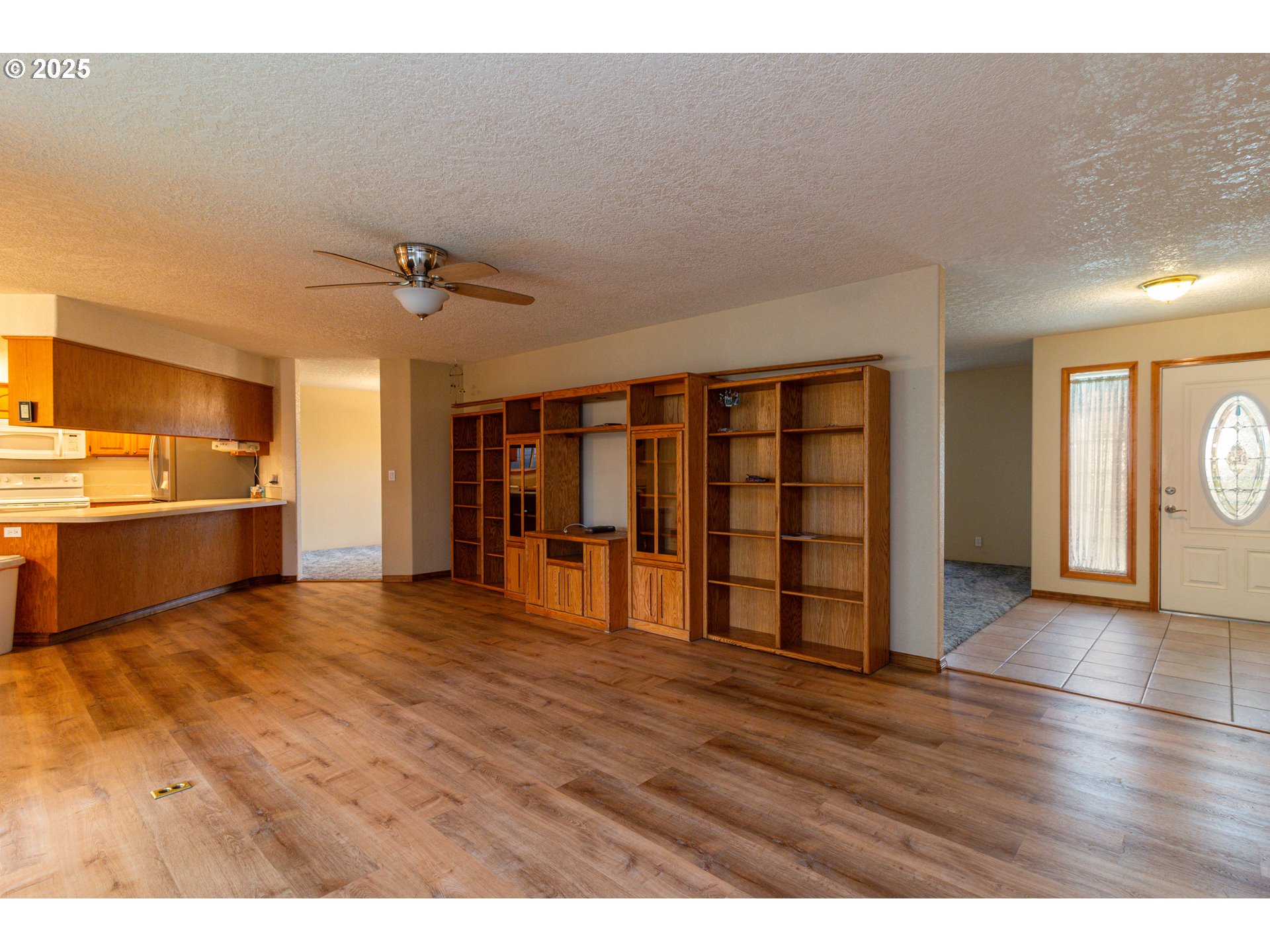 305 Northwest 9th Place Hermiston, OR 97838 - Photo 29 of 31 a view of an empty room with a window and wooden floor