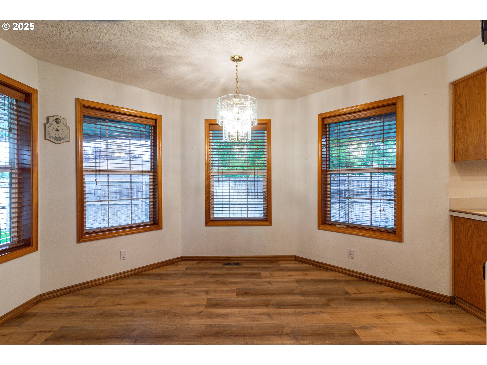 305 Northwest 9th Place Hermiston, OR 97838 - Photo 30 of 31 a view of an empty room with wooden floor and windows