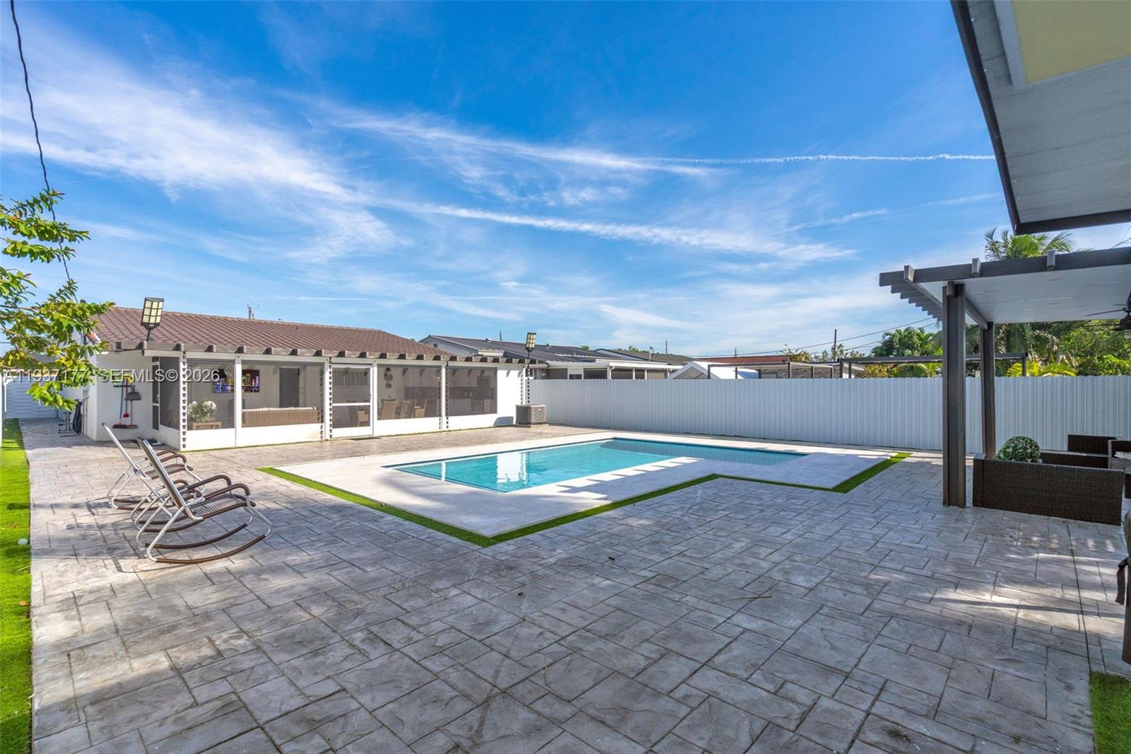 3130 Northwest 102nd Street Miami, FL 33147 - Photo 32 of 42 a view of a swimming pool with lounge chairs in patio