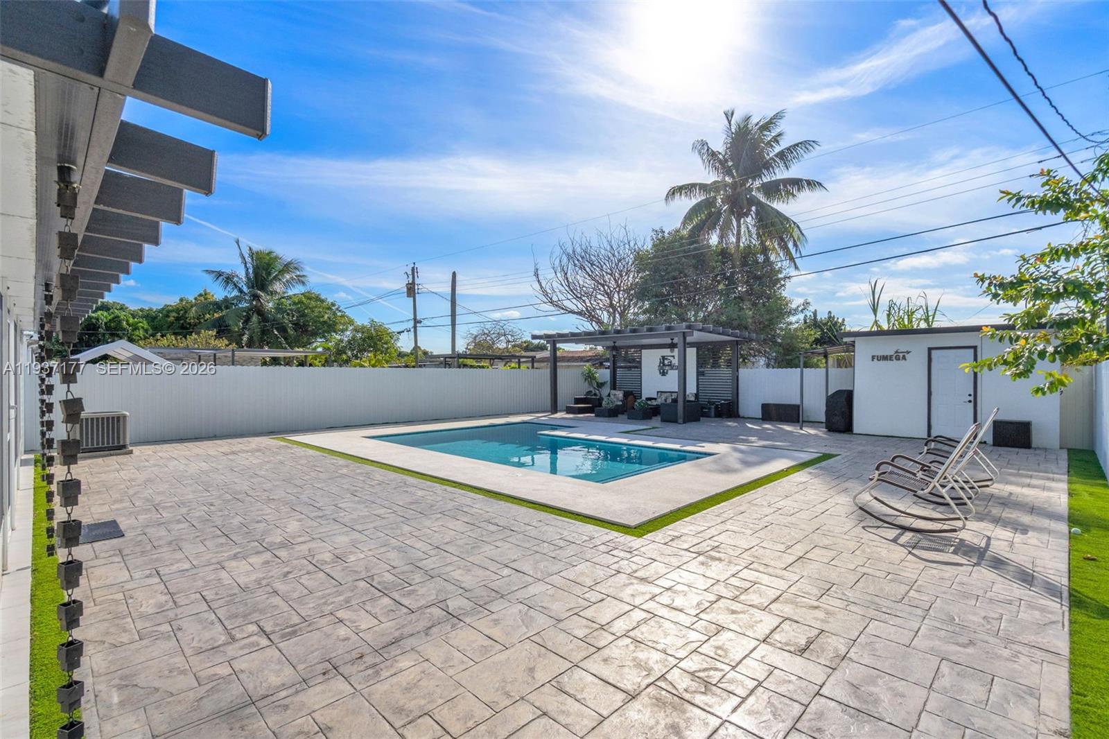 3130 Northwest 102nd Street Miami, FL 33147 - Photo 34 of 42 a view of a swimming pool with lounge chair