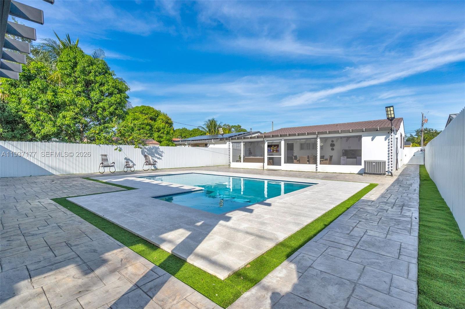 3130 Northwest 102nd Street Miami, FL 33147 - Photo 37 of 42 a view of a house with a swimming pool