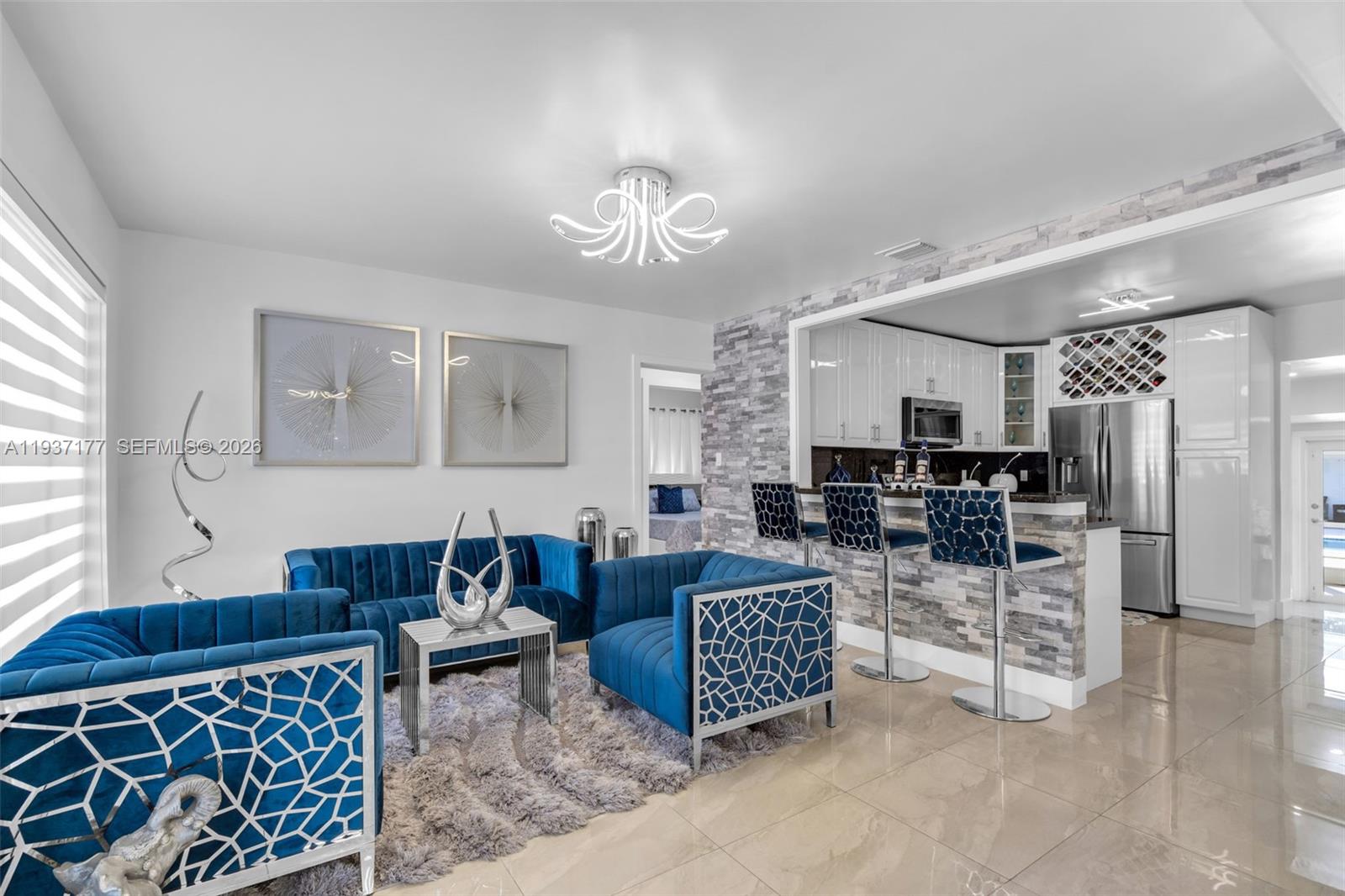 3130 Northwest 102nd Street Miami, FL 33147 - Photo 5 of 42 a living room with furniture a table and kitchen view