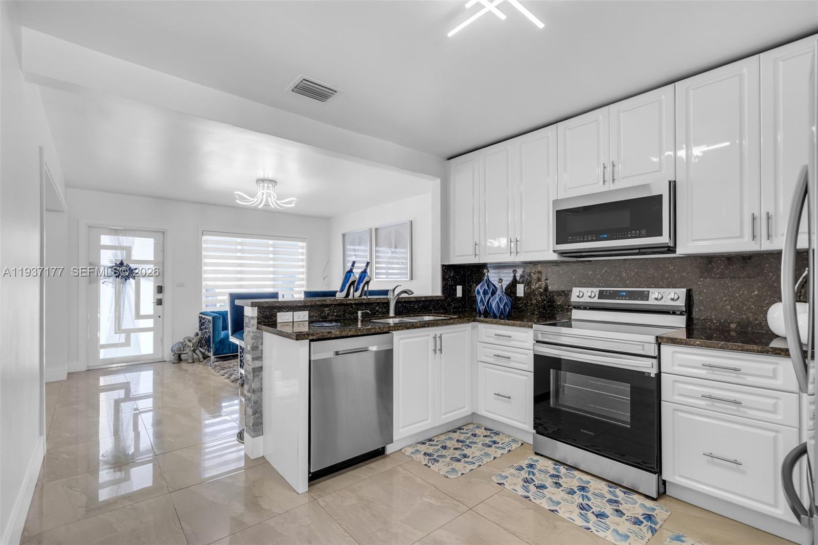 3130 Northwest 102nd Street Miami, FL 33147 - Photo 10 of 42 a kitchen with a sink stove and microwave