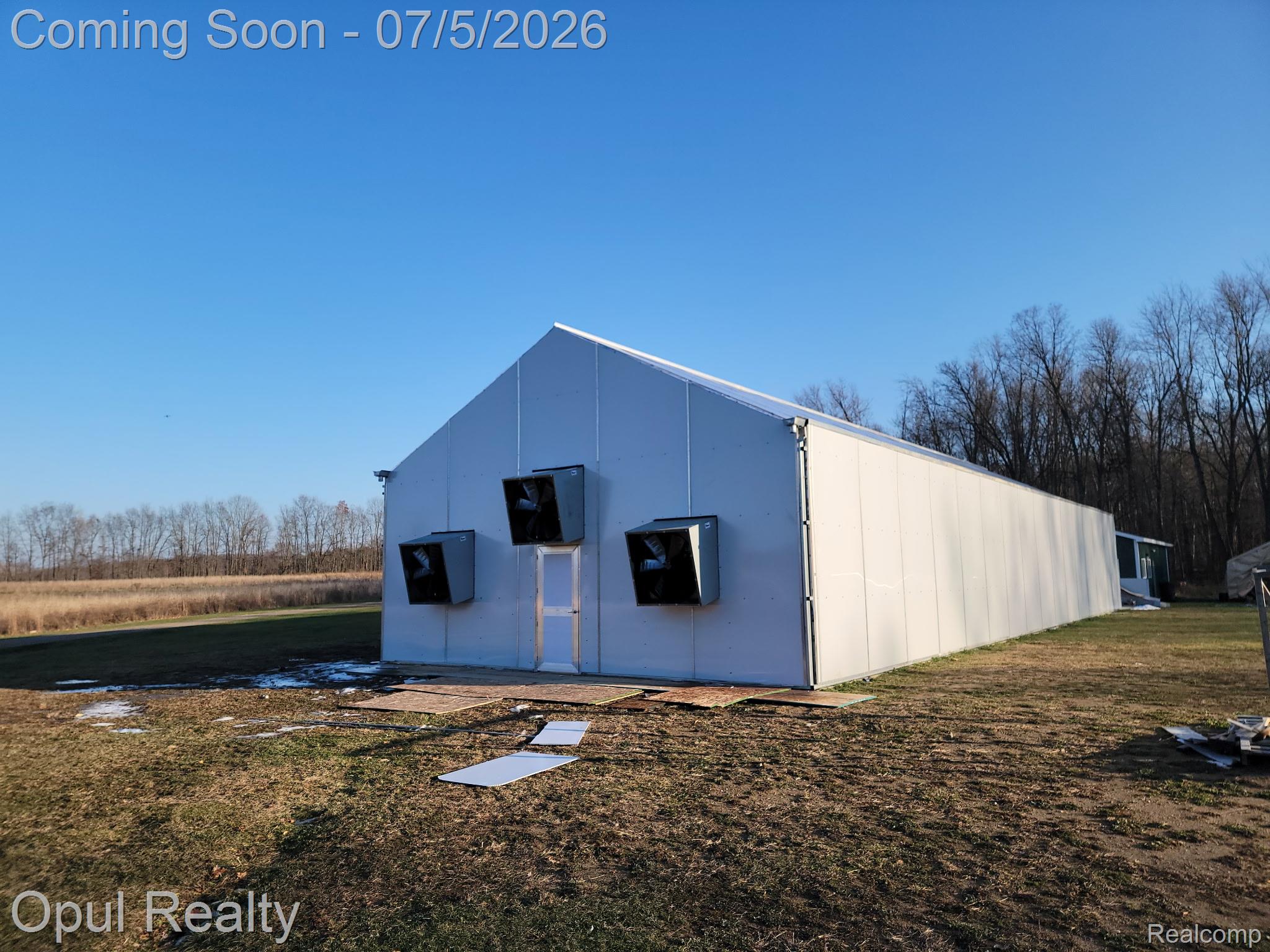 7503 Reading Road East Pittsford, MI 49271 - Photo 21 of 24 Large white agricultural building featuring a gable roof and multiple exterior ventilation units