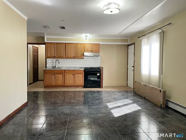 an empty room with wooden floor and a window
