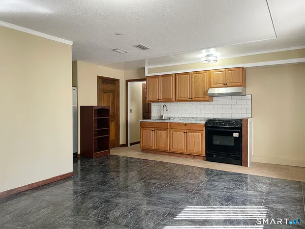 a kitchen with stainless steel appliances granite countertop a refrigerator and a stove top oven