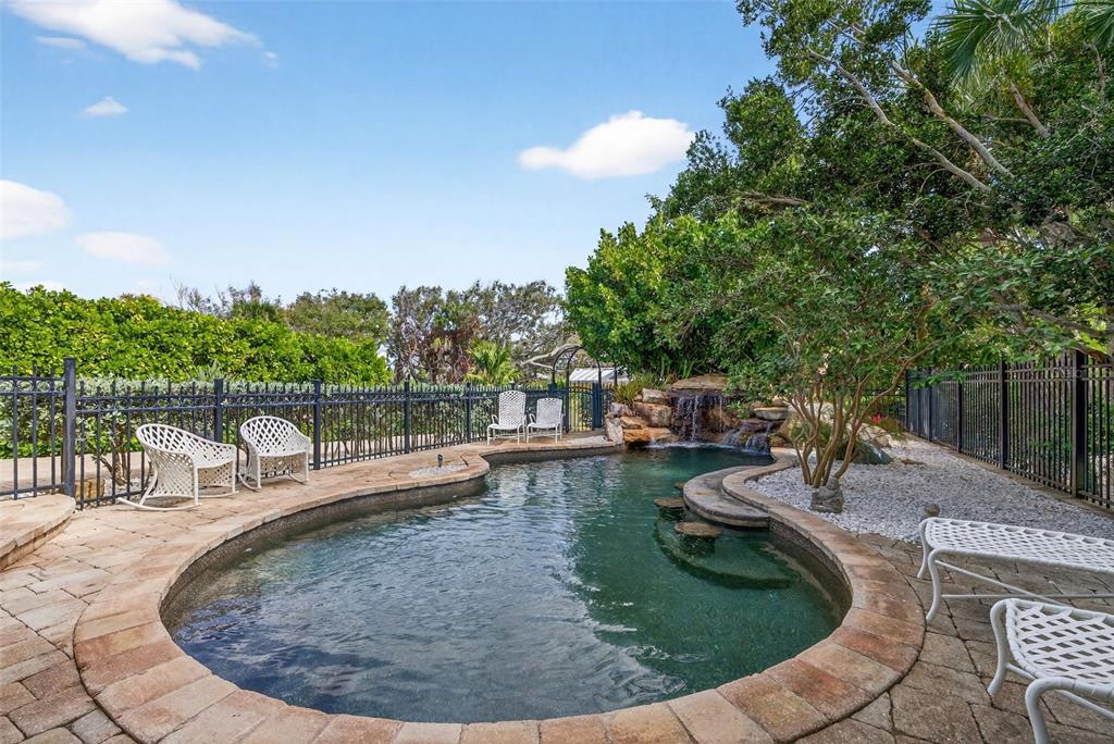 7152 Point Of Rocks Circle Sarasota, FL 34242 - Photo 13 of 88 a view of a swimming pool with a sitting space
