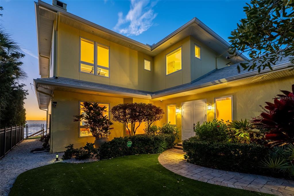 7152 Point Of Rocks Circle Sarasota, FL 34242 - Photo 2 of 88 a view of a house with a small yard plants and a large tree