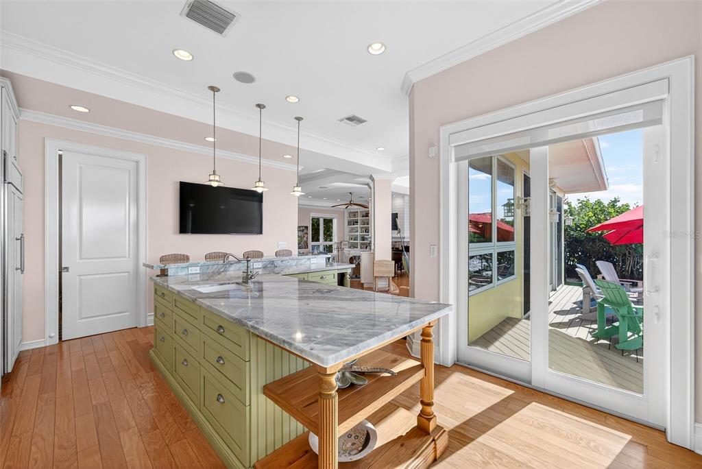 7152 Point Of Rocks Circle Sarasota, FL 34242 - Photo 26 of 88 a kitchen with stainless steel appliances granite countertop a stove and a view of living room