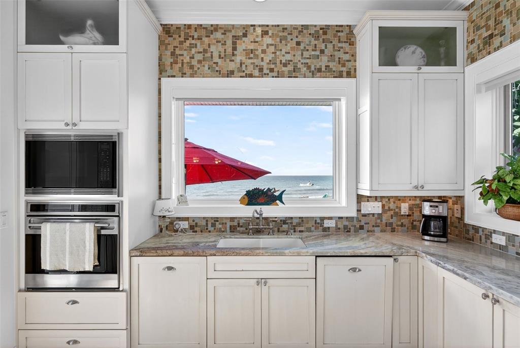 7152 Point Of Rocks Circle Sarasota, FL 34242 - Photo 28 of 88 a kitchen with stainless steel appliances granite countertop a stove a sink and a microwave