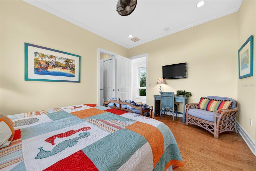 7152 Point Of Rocks Circle Sarasota, FL 34242 - Photo 57 of 88 a bedroom that has a bed and a chair in it