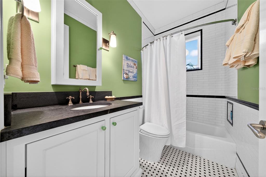 7152 Point Of Rocks Circle Sarasota, FL 34242 - Photo 58 of 88 a bathroom with a sink a toilet a mirror a vanity and shower