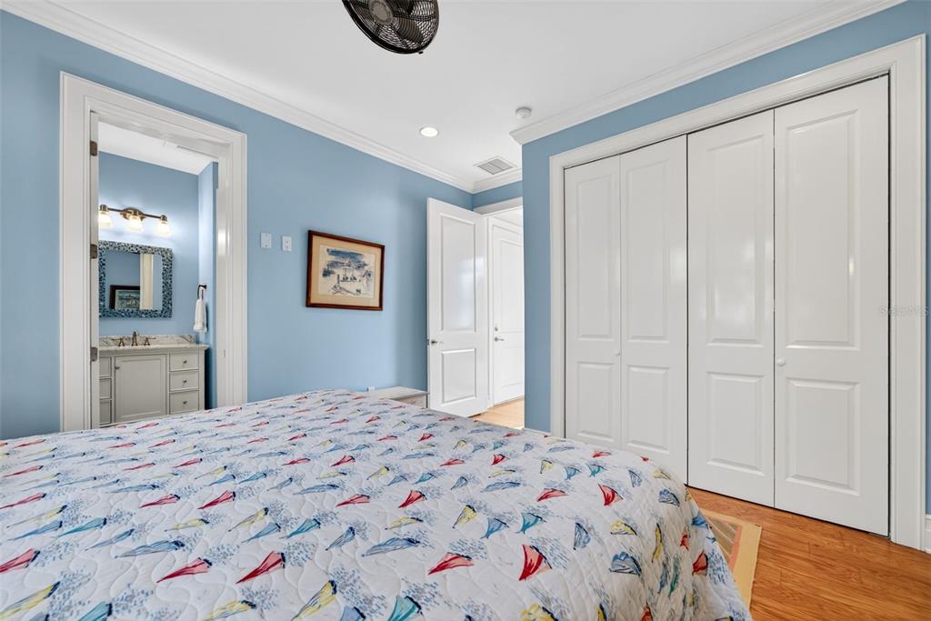 7152 Point Of Rocks Circle Sarasota, FL 34242 - Photo 60 of 88 a bedroom with a bed and a mirror