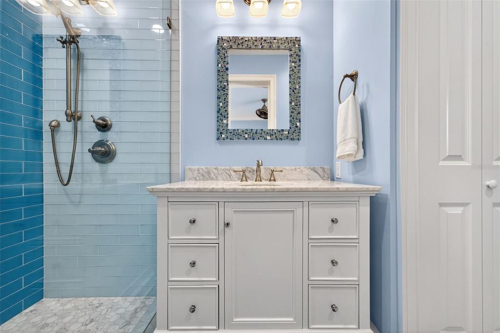 7152 Point Of Rocks Circle Sarasota, FL 34242 - Photo 61 of 88 a bathroom with a sink vanity and mirror