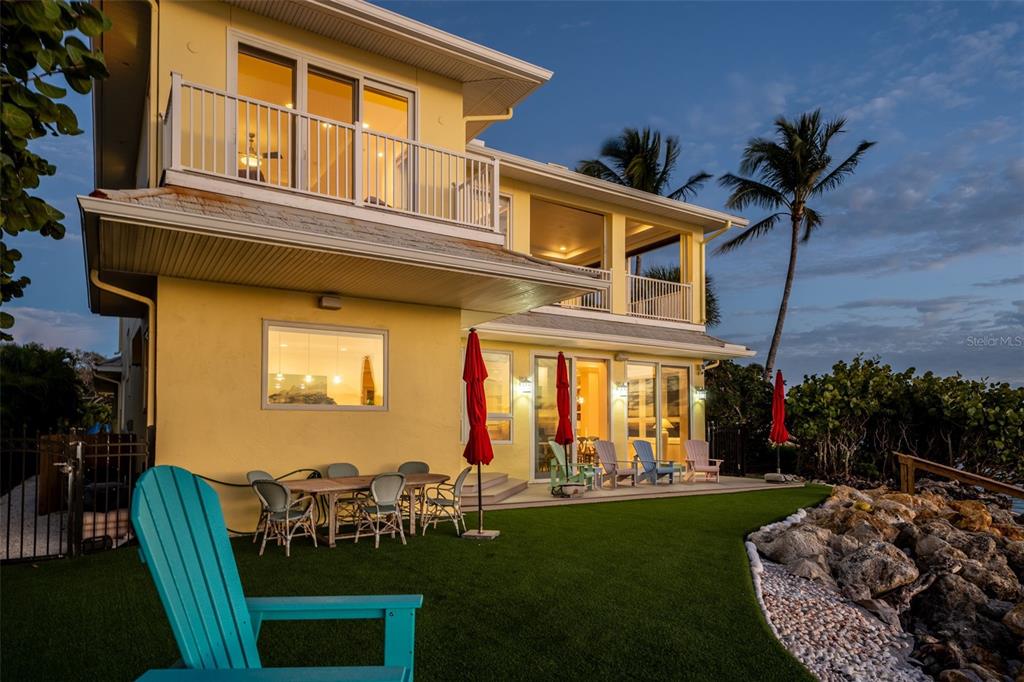 7152 Point Of Rocks Circle Sarasota, FL 34242 - Photo 71 of 88 a view of a house with a backyard porch and sitting area