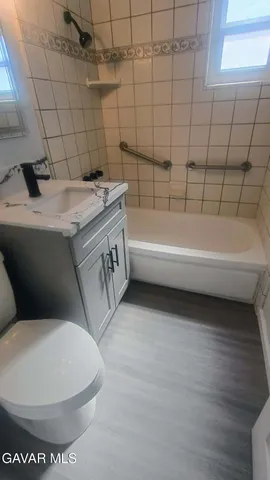 a bathroom with a sink a toilet and bathtub