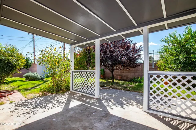a view of a yard with wooden fence