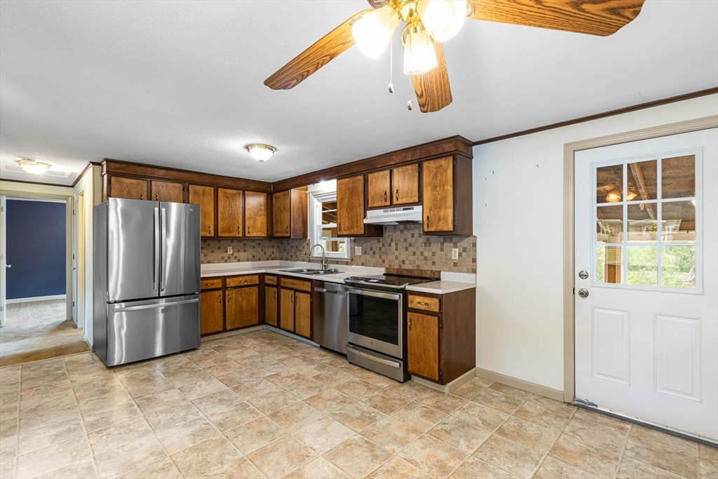 99 Swansom Road Swansea, MA 02777 - Photo 16 of 42 a kitchen with stainless steel appliances granite countertop a refrigerator and a sink