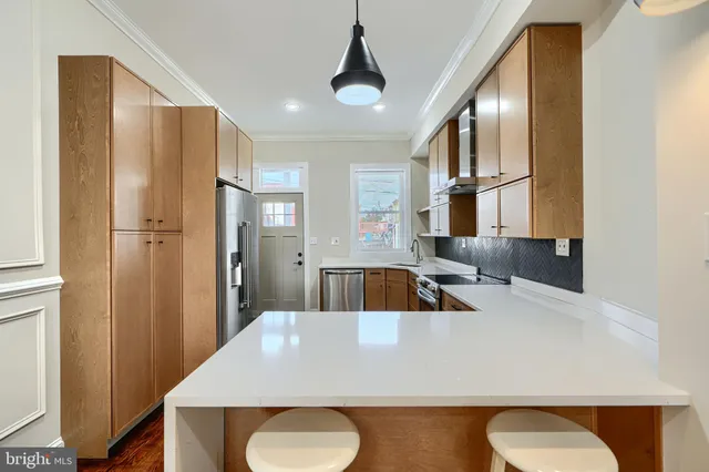 a view of a kitchen with refrigerator and cabinet