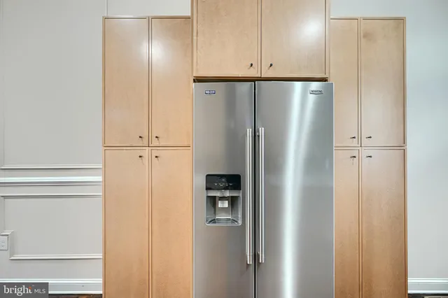 a view of a hallway with wooden floor and entryway