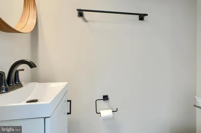 a bathroom with a toilet a sink a vanity and mirror