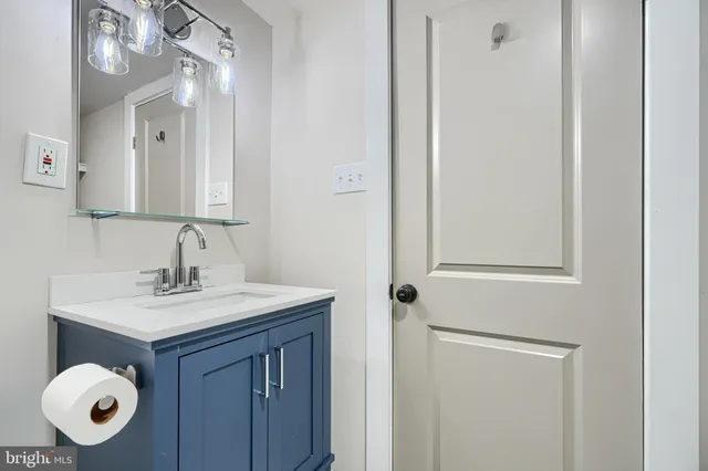 a view of an empty room with wooden floor and closet