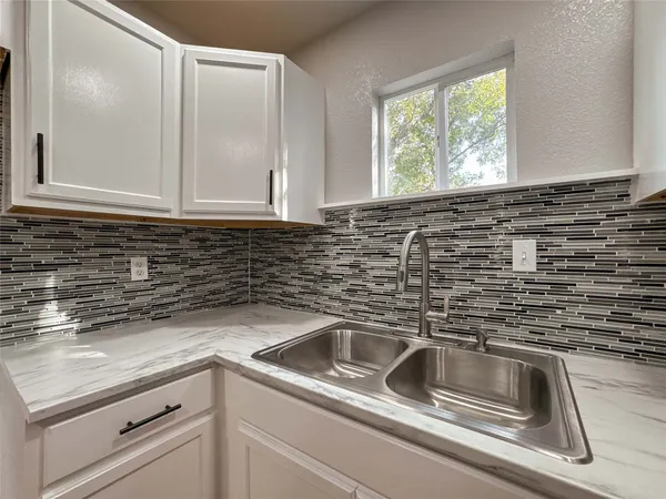 a kitchen with a sink and cabinets