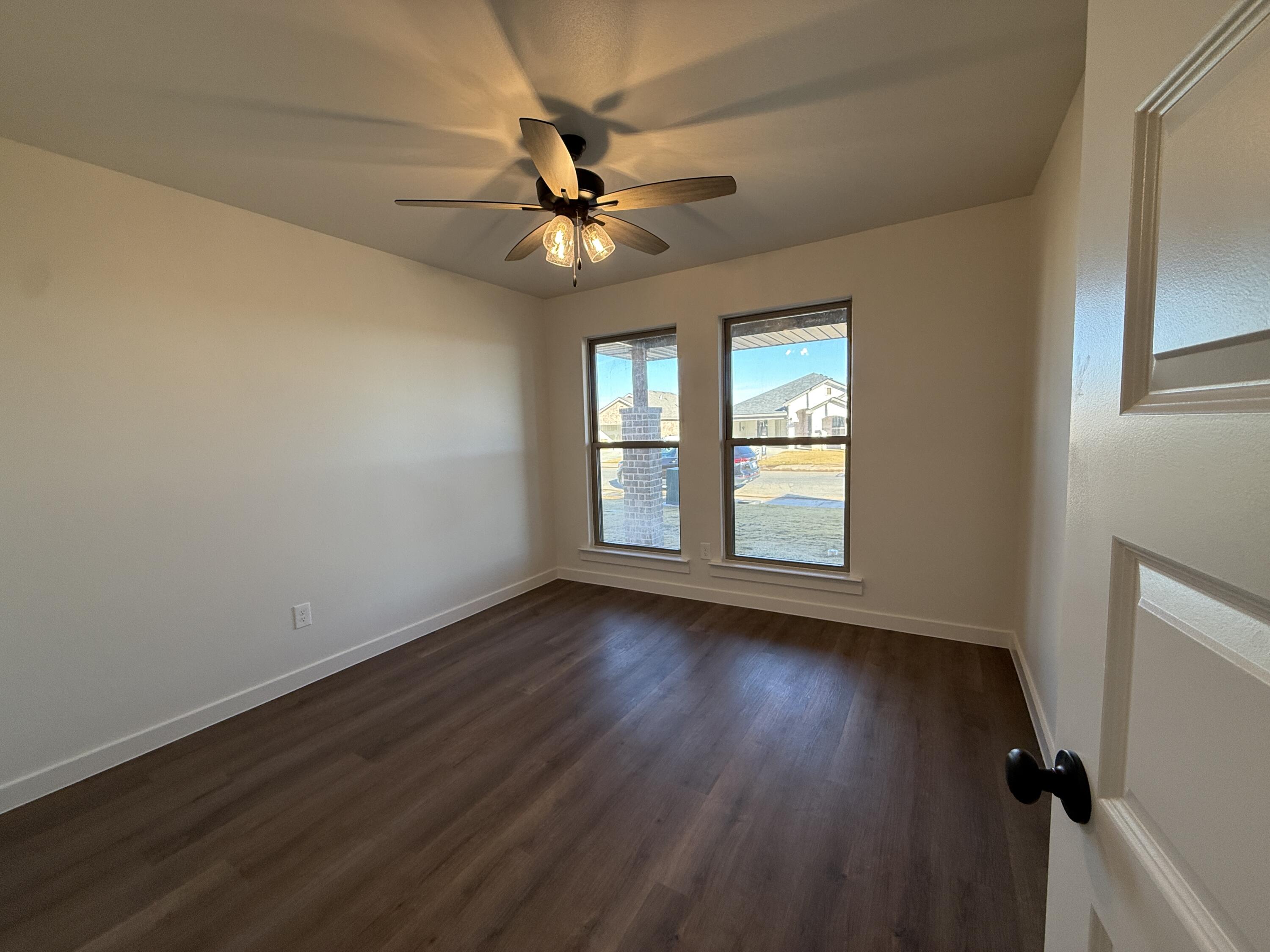 3015 138th Place Lubbock, TX 79423 - Photo 12 of 13 a view of an empty room with wooden floor and a window