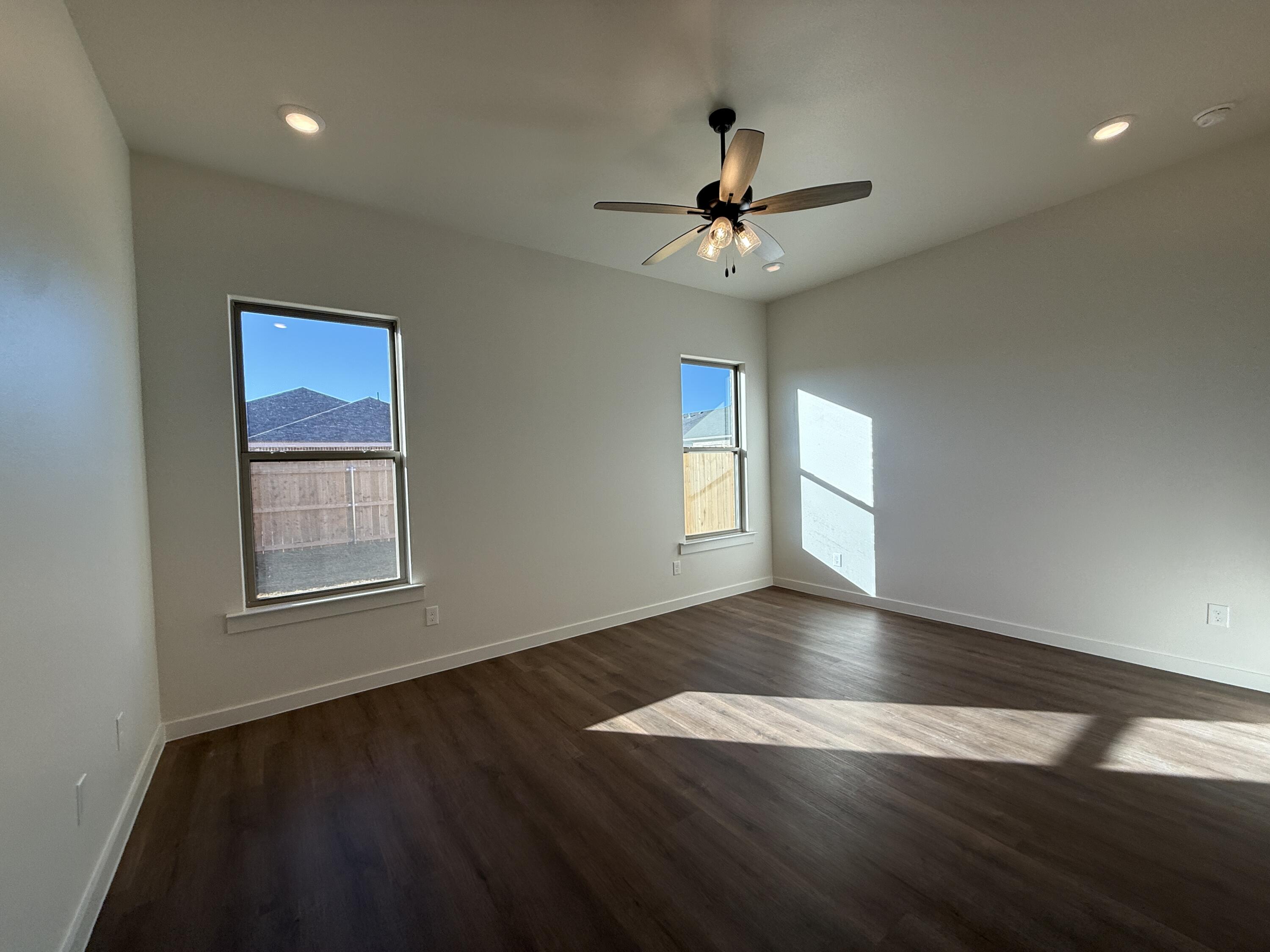 3015 138th Place Lubbock, TX 79423 - Photo 4 of 13 a view of an empty room with wooden floor and a window