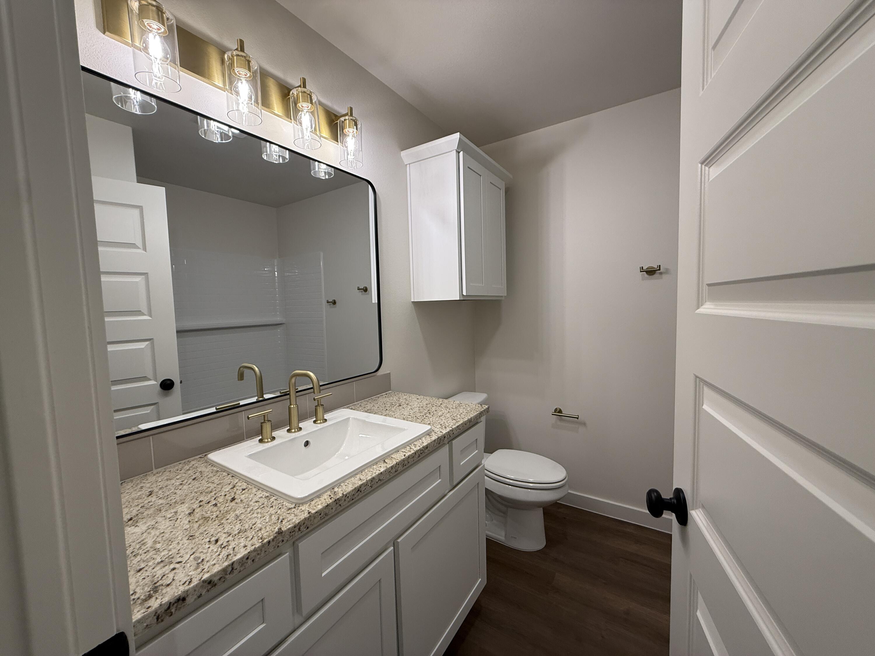 3015 138th Place Lubbock, TX 79423 - Photo 10 of 13 a bathroom with a sink and a mirror