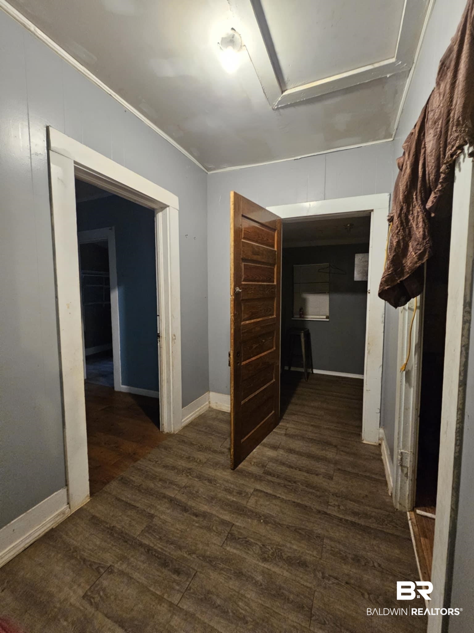 31398 Brady Road Robertsdale, AL 36567 - Photo 8 of 17 Corridor with baseboards, wood finished floors, and crown molding