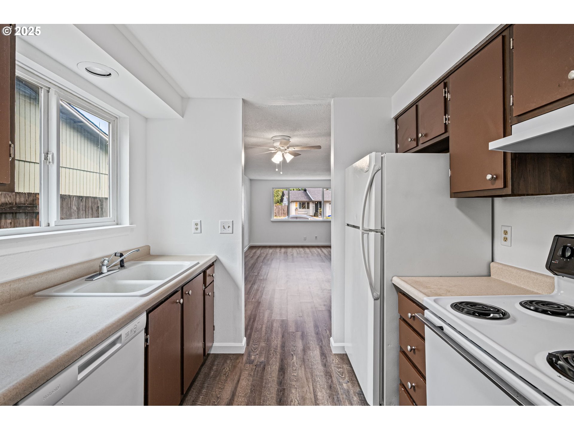 4883 Elderberry Loop Springfield, OR 97478 - Photo 11 of 23 a kitchen with a sink a stove and refrigerator
